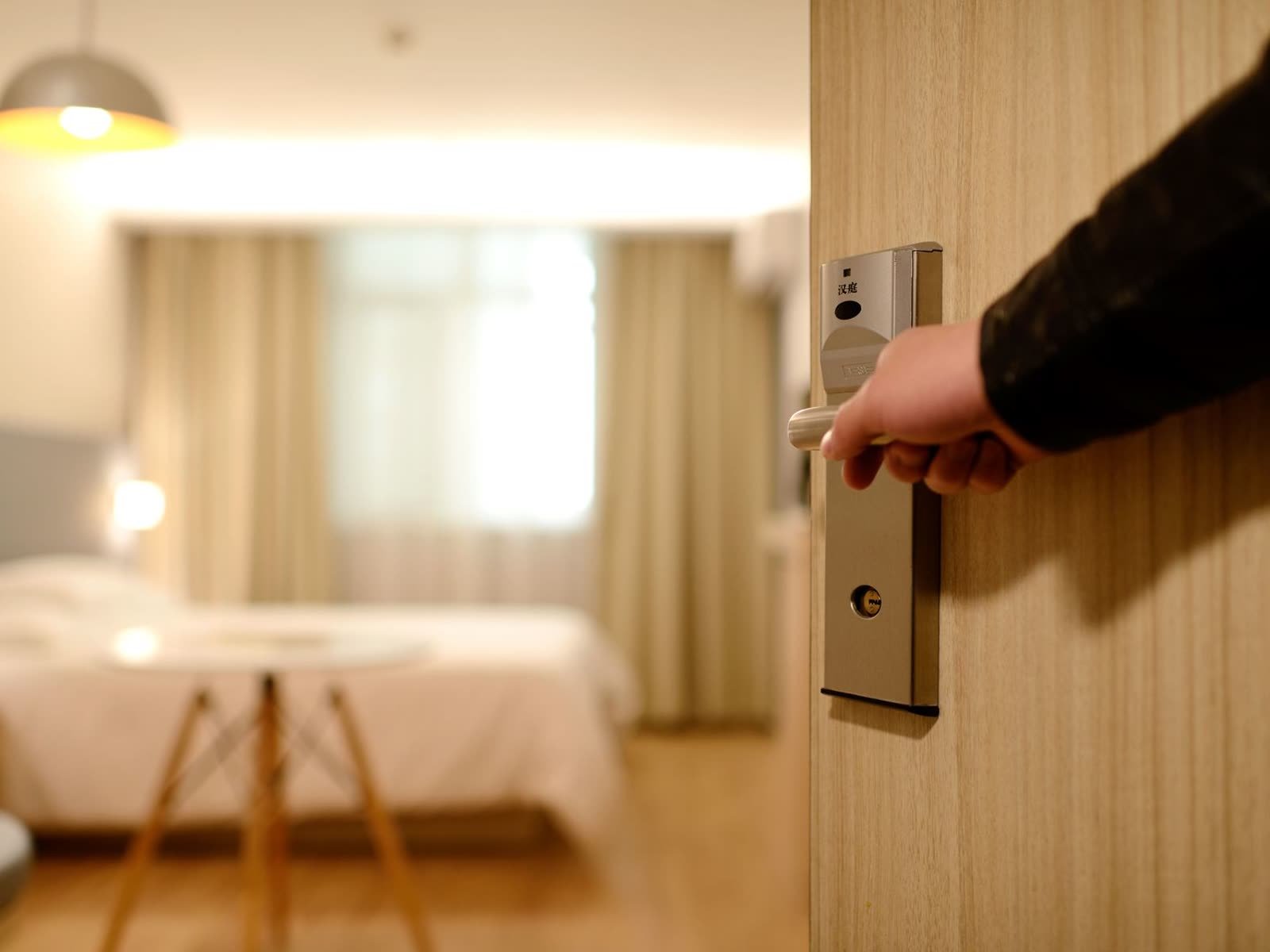 A guest opening a hotel room with a key card